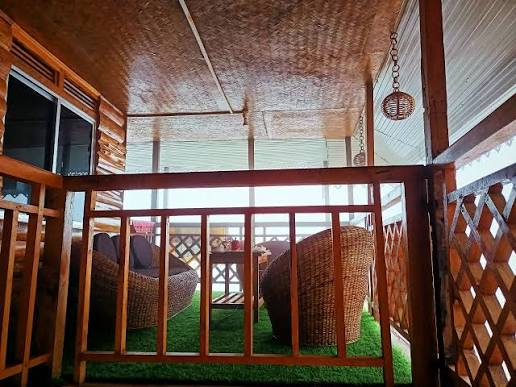 Master Room Skywalk — balcony lounge with cane sofas