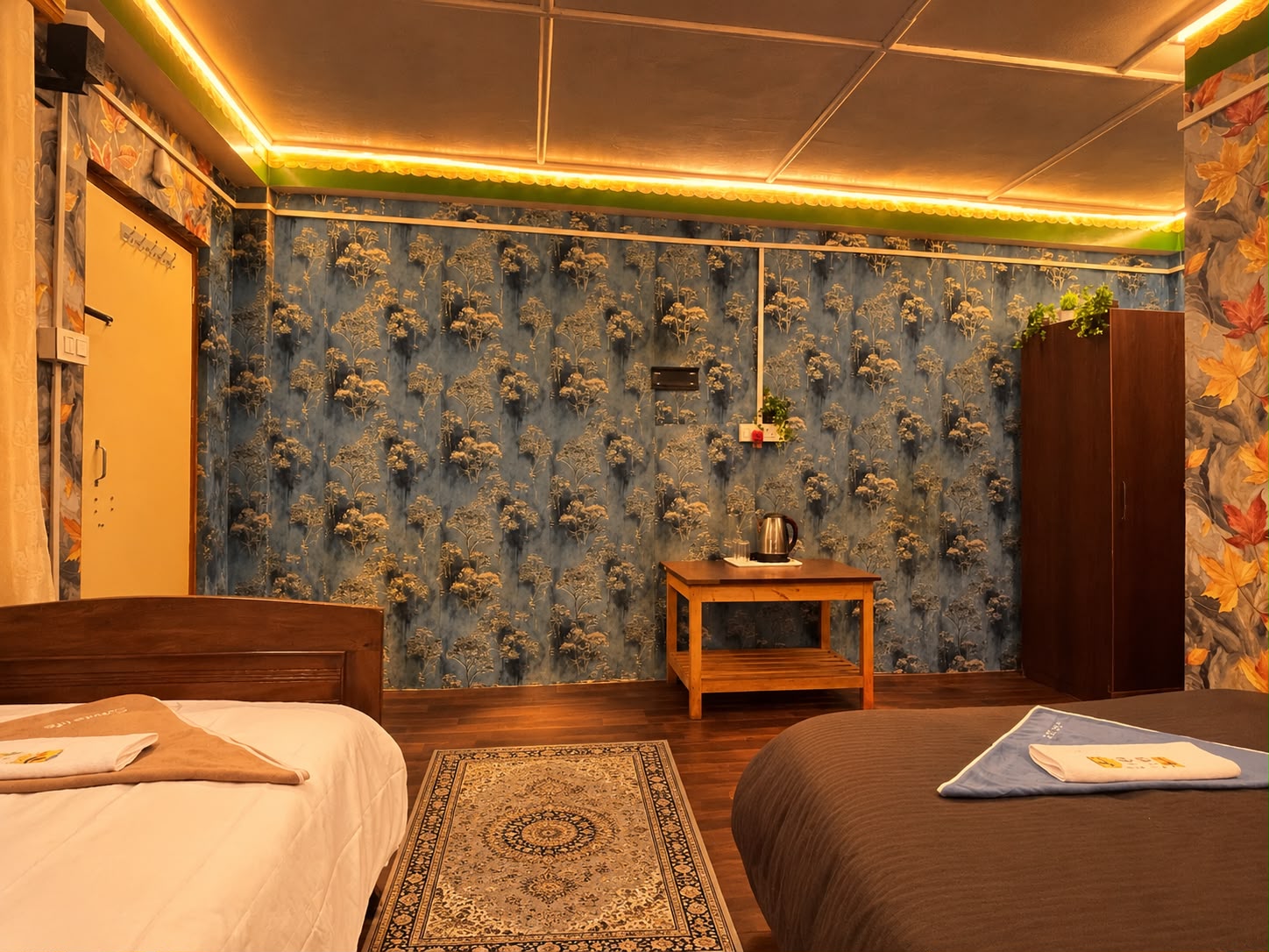 Kanchenjunga Suite — king bed and single bed facing a tea table and wardrobe