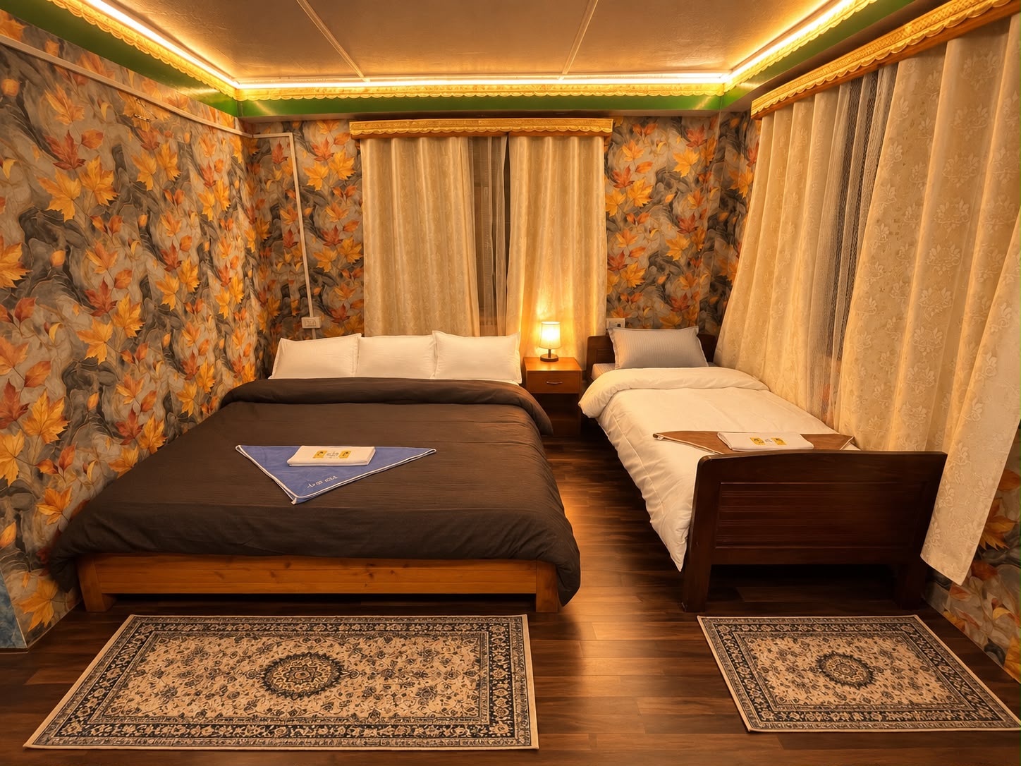 Kanchenjunga Suite — king bed and single bed with warm lighting and cream curtains