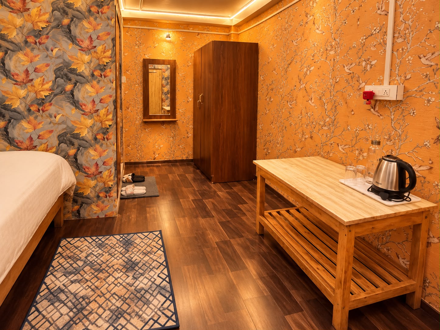 Skywalk Suite — floral-wallpaper room with a wardrobe, mirror and wooden tea table