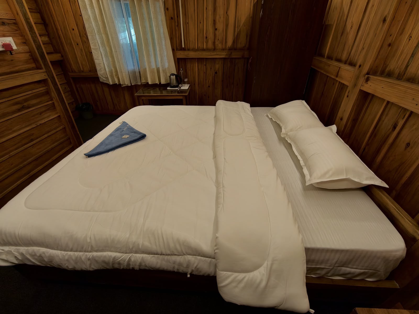 Cedar Nest — neatly made double bed with fresh white linen